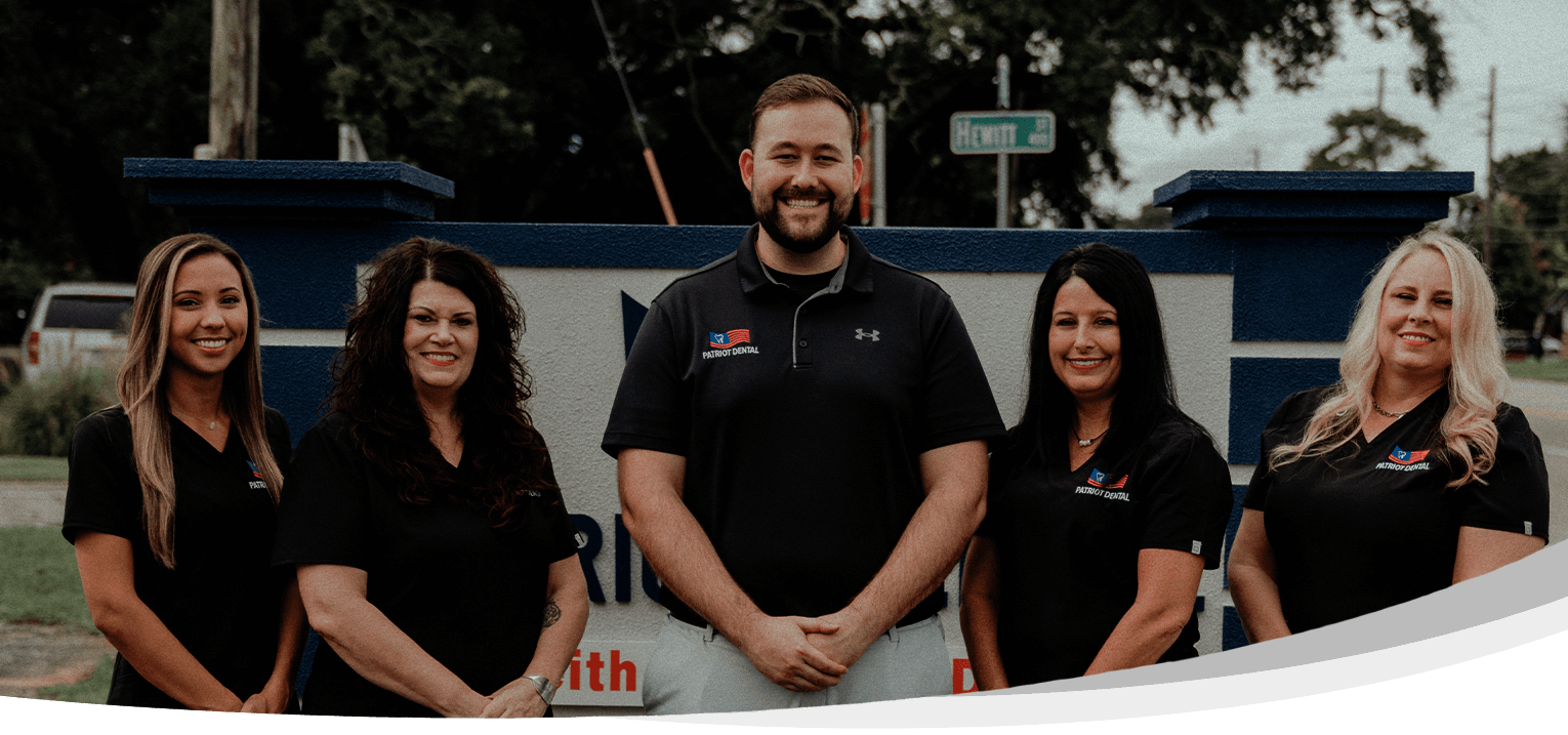 Pensacola dentist and team smiling outdoors